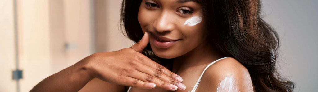 Woman Applying Cream to Her Skin