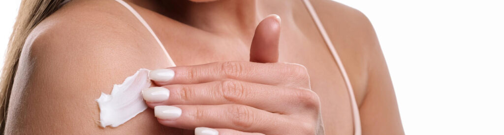 Woman Applying Cream to Scar